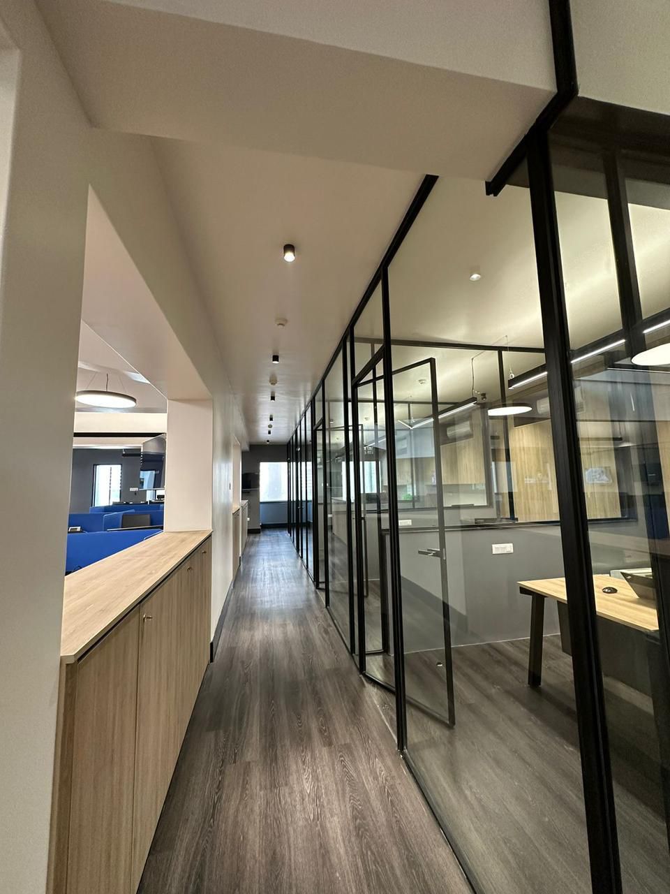Glass-partitioned office corridor